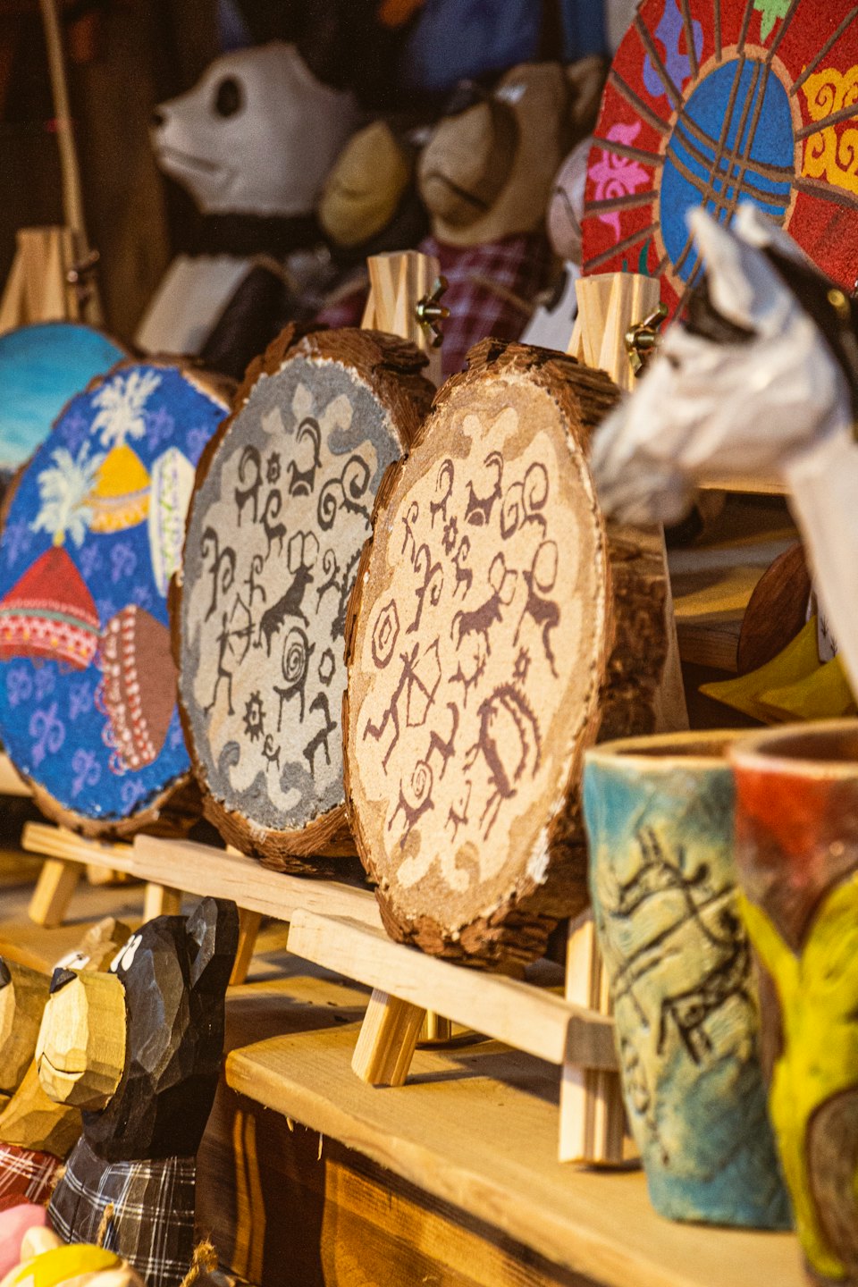 Handcrafted wooden souvenirs and ceramic mugs for sale.